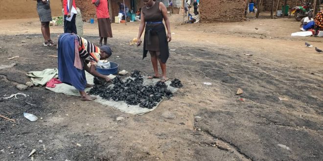 Amongin serving a customer charcoal for 1000/=