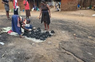 Amongin serving a customer charcoal for 1000/=